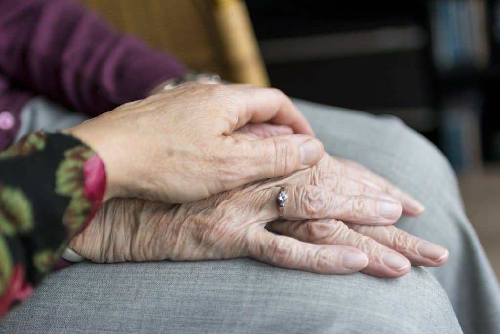Old people holding hands